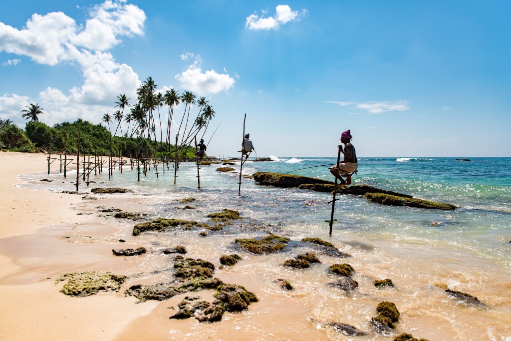 Stilt fisherman at Mirissa beach in Sri Lanka