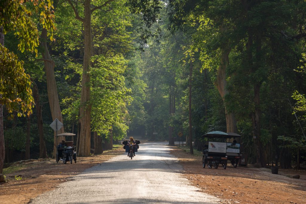 Man riding motorbike near Angkor Wat in Siem Reap Cambodia